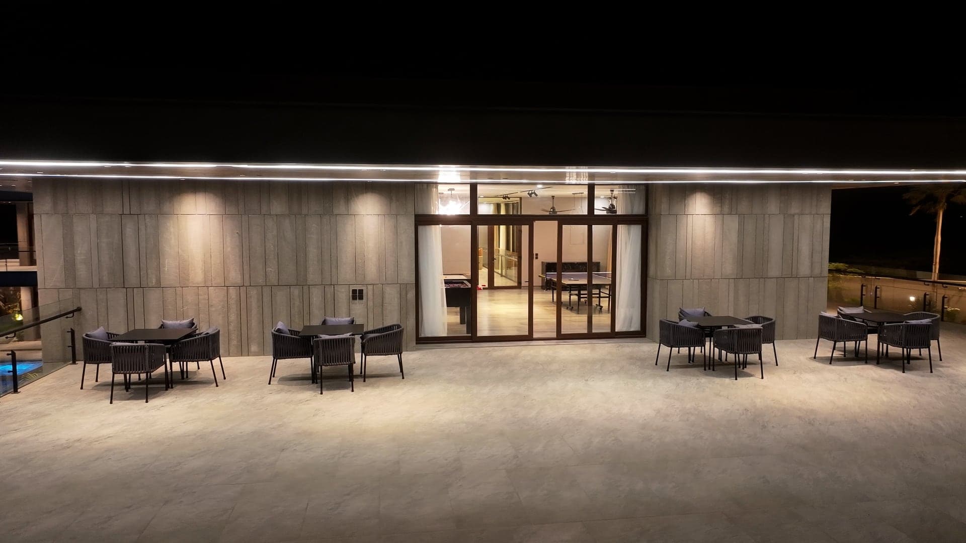 Rooftop terrace lounge illuminated at night at FHU Resorts Karachi