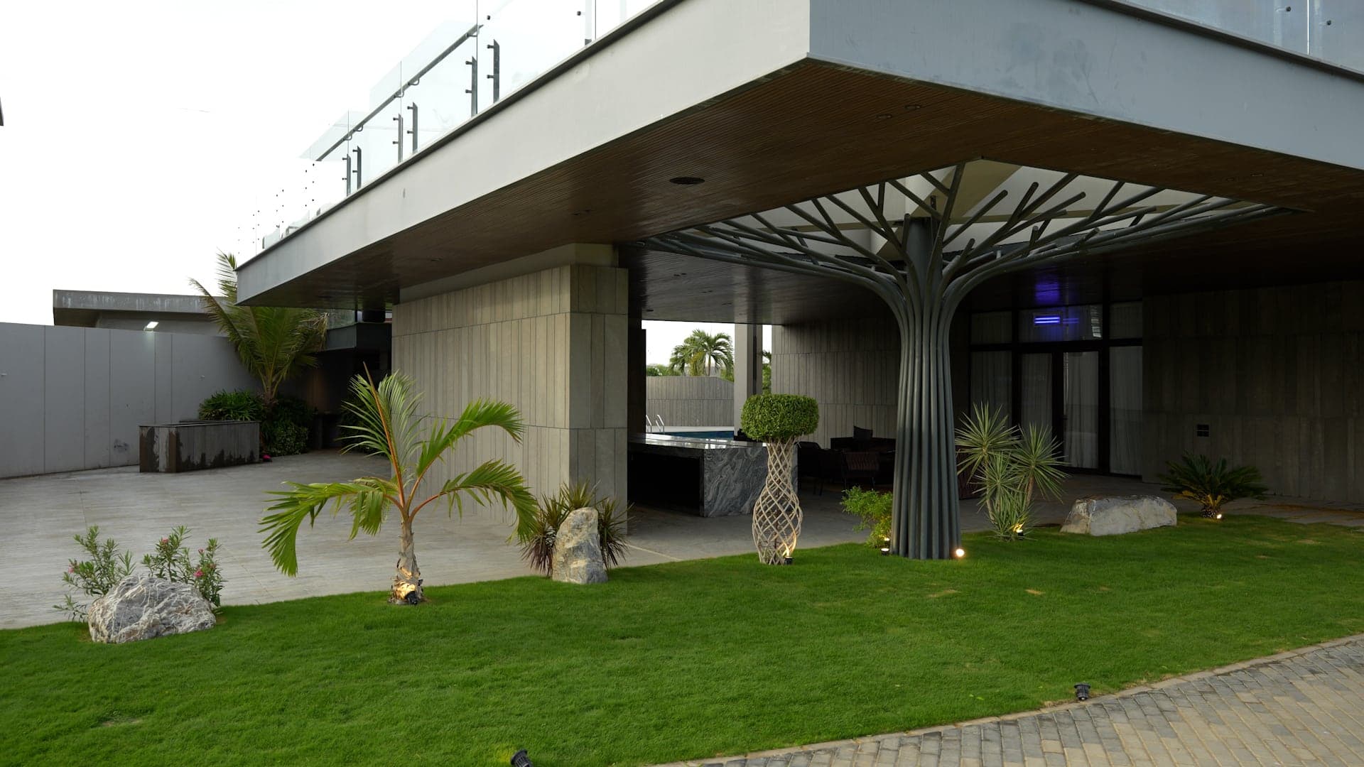 Sculptural steel tree-column canopy over the landscaped garden courtyard at FHU Resorts Karachi